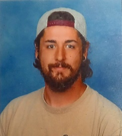 A person with a beard and a baseball capDescription automatically generated